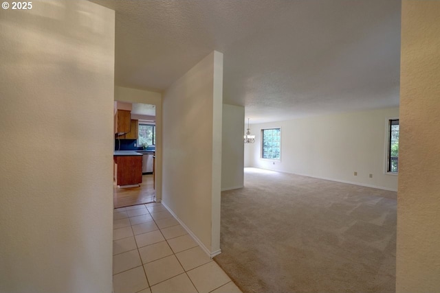 1630 SW 14th St, Warrenton, OR 97146 - hall with a chandelier, light tile patterned floors, and light carpet