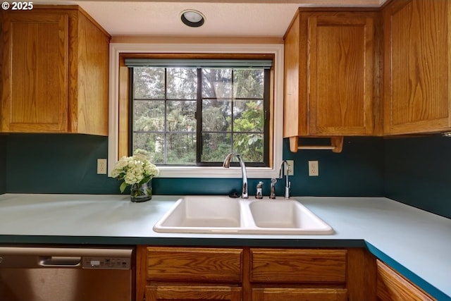 1630 SW 14th St, Warrenton, OR 97146 - kitchen with stainless steel dishwasher, brown cabinetry, and light countertops