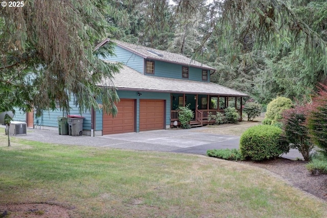 1630 SW 14th St, Warrenton, OR 97146 - view of front of house featuring covered porch, asphalt driveway, a front lawn, and a garage