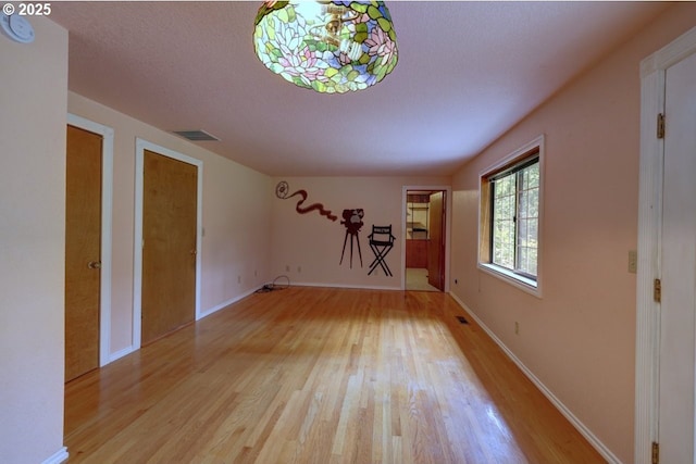 1630 SW 14th St, Warrenton, OR 97146 - unfurnished living room featuring light wood-style flooring and baseboards
