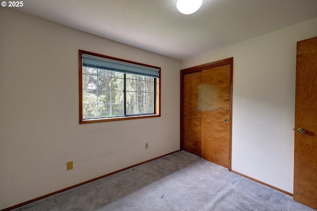 1630 SW 14th St, Warrenton, OR 97146 - unfurnished bedroom with carpet flooring, a closet, and a textured ceiling