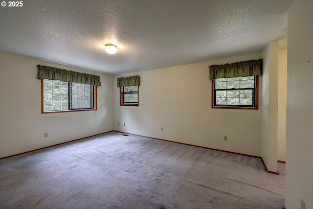 1630 SW 14th St, Warrenton, OR 97146 - carpeted empty room featuring a textured ceiling and healthy amount of natural light
