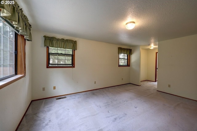 1630 SW 14th St, Warrenton, OR 97146 - empty room featuring light carpet and a textured ceiling