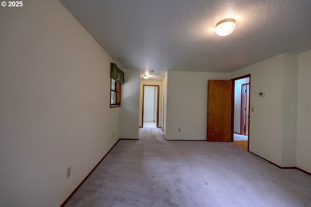 1630 SW 14th St, Warrenton, OR 97146 - unfurnished room featuring a textured ceiling and light colored carpet
