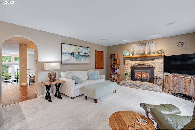 15137 SW Peachtree Dr, Portland, OR 97224 - carpeted living room with arched walkways and a fireplace