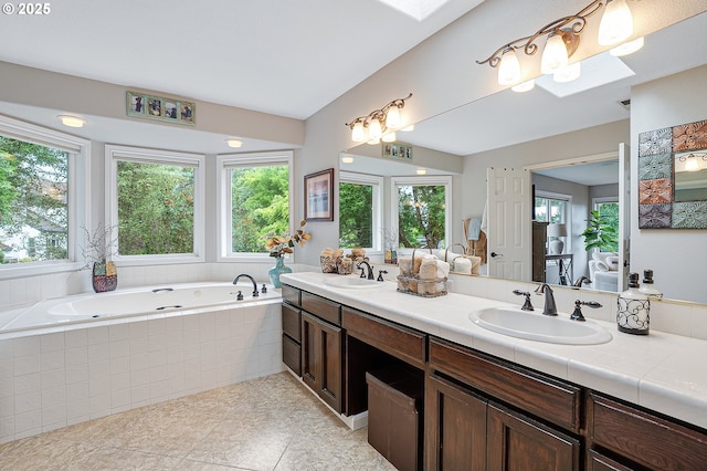 15137 SW Peachtree Dr, Portland, OR 97224 - full bath with double vanity, healthy amount of natural light, a garden tub, and tile patterned flooring