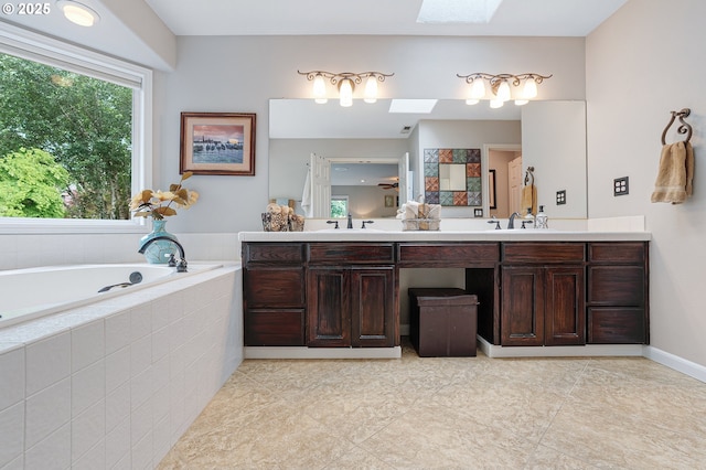 15137 SW Peachtree Dr, Portland, OR 97224 - full bath featuring a skylight, double vanity, a bath, and tile patterned floors