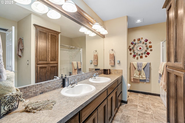 15137 SW Peachtree Dr, Portland, OR 97224 - bathroom with a shower with door, double vanity, decorative backsplash, and stone finish flooring