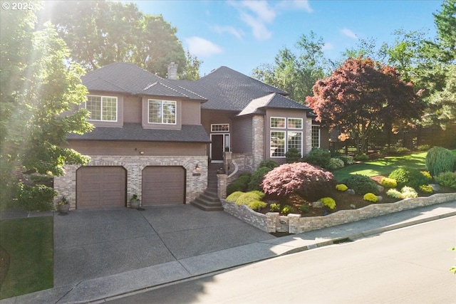 15137 SW Peachtree Dr, Portland, OR 97224 - view of front of house with concrete driveway, a garage, stone siding, and a front lawn