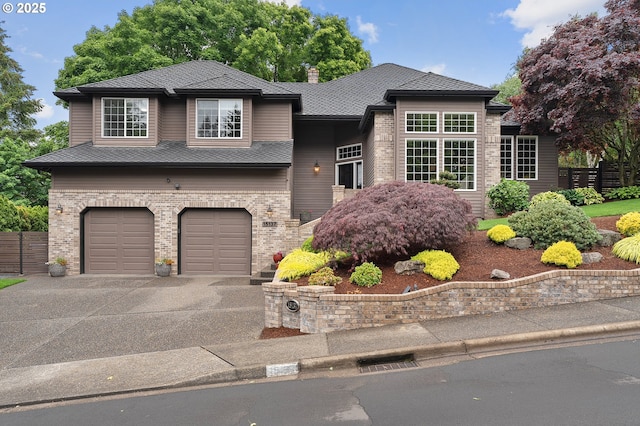 15137 SW Peachtree Dr, Portland, OR 97224 - view of front facade with an attached garage, brick siding, driveway, and a chimney