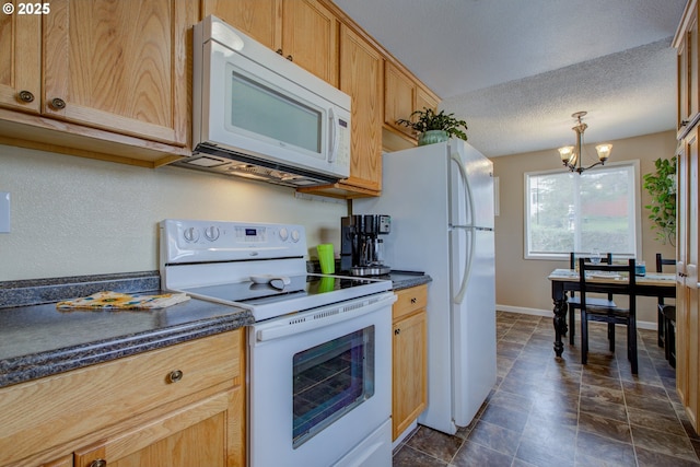 kitchen featuring a notable chandelier, white appliances, dark countertops, and a textured ceiling