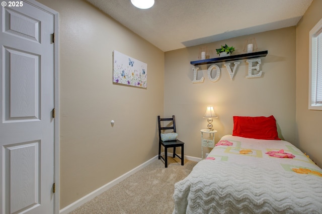 bedroom featuring baseboards, a textured ceiling, and carpet flooring