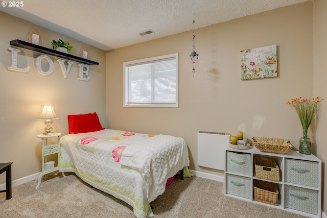 bedroom featuring baseboards, visible vents, carpet floors, and a textured ceiling