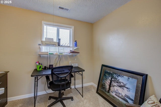 carpeted office featuring baseboards, visible vents, and a textured ceiling