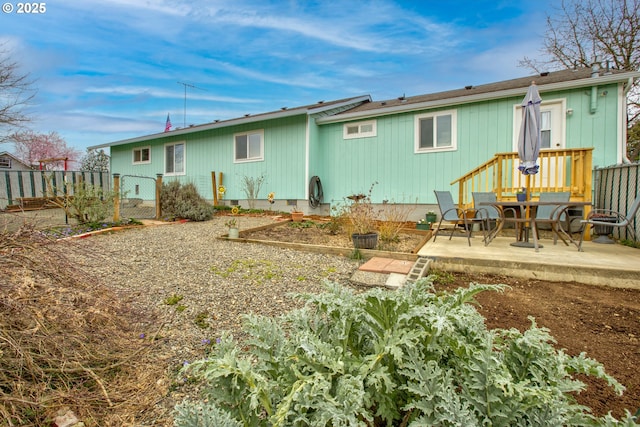 back of house with crawl space, a patio, and fence