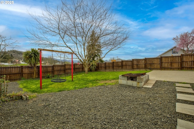 view of yard featuring a patio area, a fire pit, and a fenced backyard