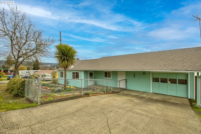 ranch-style house with driveway, roof with shingles, an attached garage, and fence