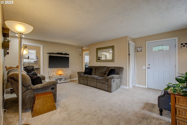 living area featuring a wealth of natural light, baseboards, and carpet