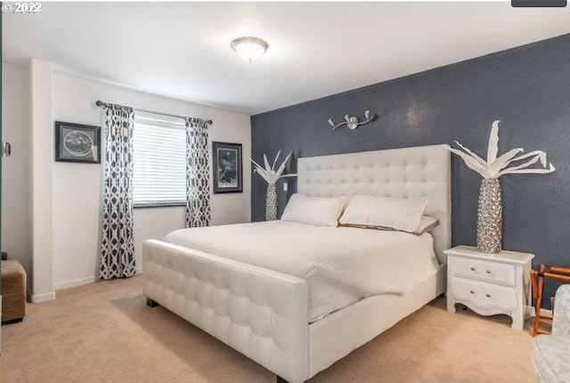 bedroom featuring light carpet