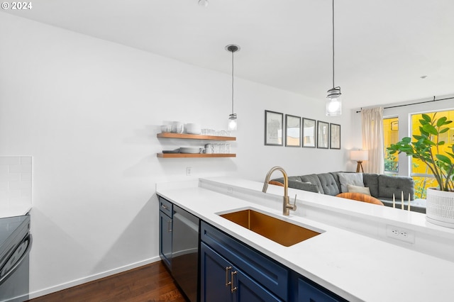 1125 NW 9th Ave Unit 419, Portland, OR 97209 - kitchen with a sink, blue cabinetry, dishwasher, dark wood finished floors, and light countertops