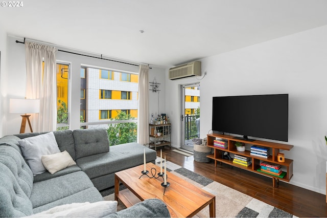 1125 NW 9th Ave Unit 419, Portland, OR 97209 - living area with a wall mounted AC, hardwood / wood-style floors, and baseboards