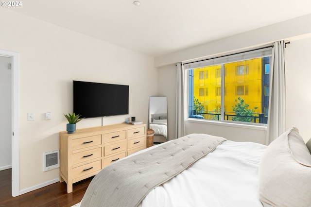 1125 NW 9th Ave Unit 419, Portland, OR 97209 - bedroom with dark wood-style flooring, baseboards, and heating unit