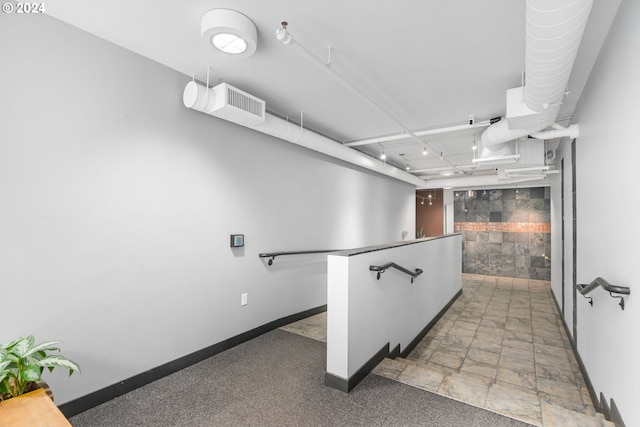 1125 NW 9th Ave Unit 419, Portland, OR 97209 - hall featuring baseboards and stone finish floors