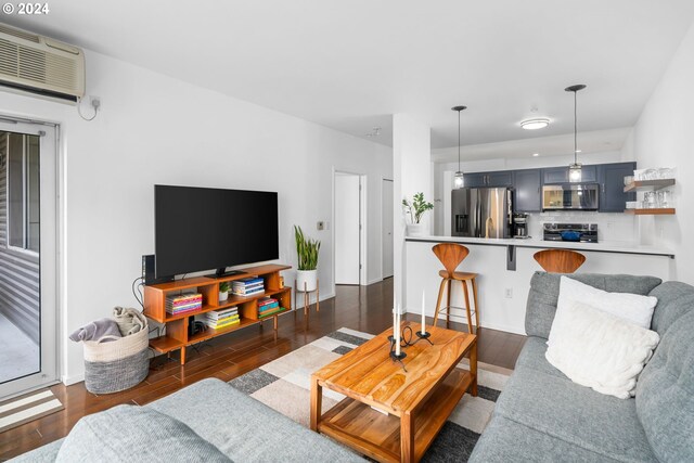1125 NW 9th Ave Unit 419, Portland, OR 97209 - living area with a wall mounted air conditioner and dark wood finished floors