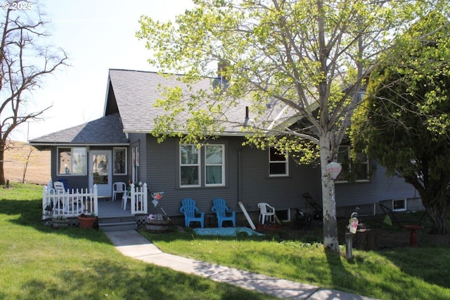 bungalow with roof with shingles and a front yard