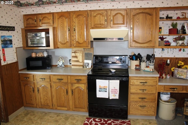kitchen featuring light countertops, brown cabinetry, black appliances, and extractor fan