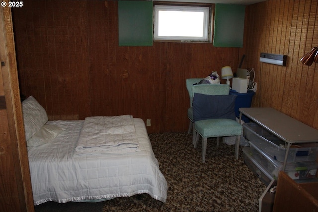 bedroom with wooden walls and carpet flooring