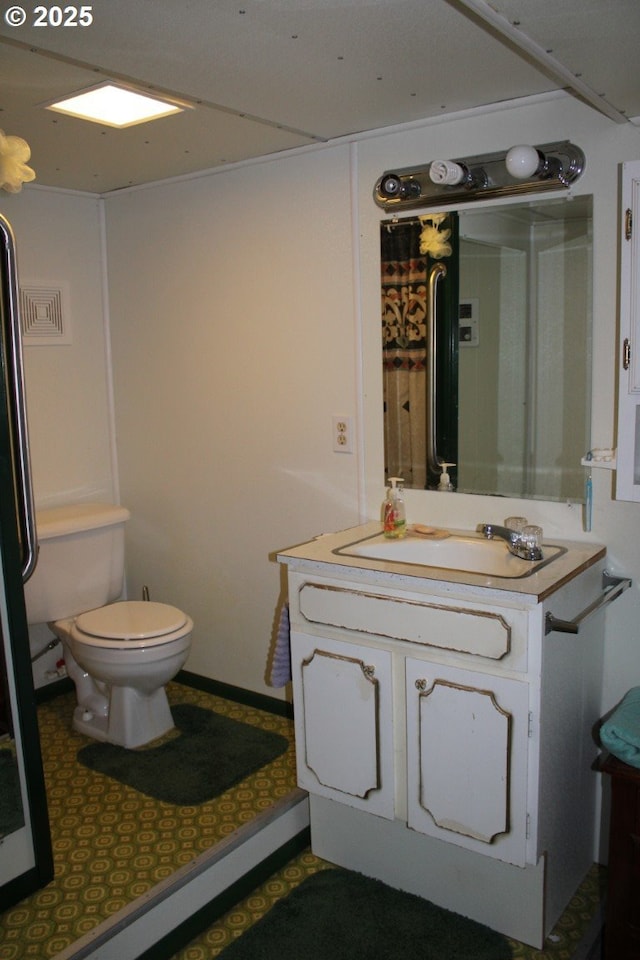 bathroom with vanity, visible vents, and toilet