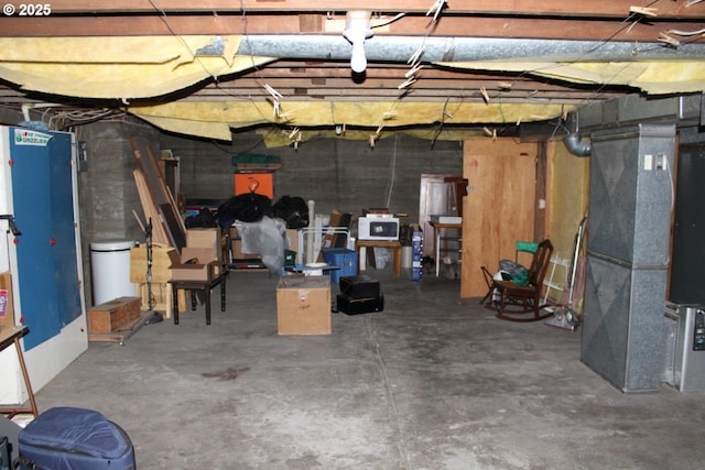 unfinished basement featuring heating unit