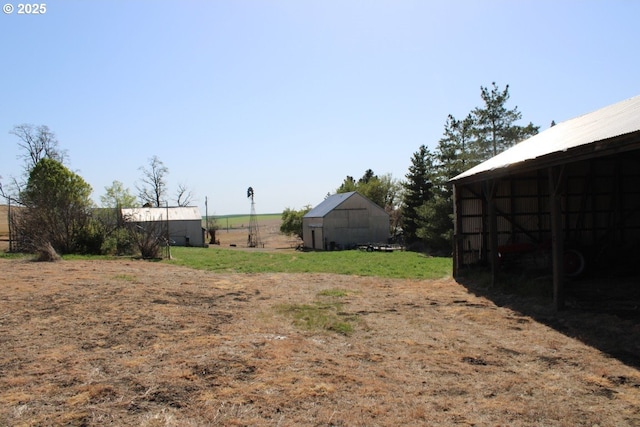 view of yard featuring an outbuilding and an outdoor structure