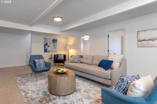 carpeted living room featuring beamed ceiling