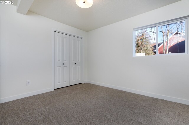 unfurnished bedroom with a closet and carpet flooring