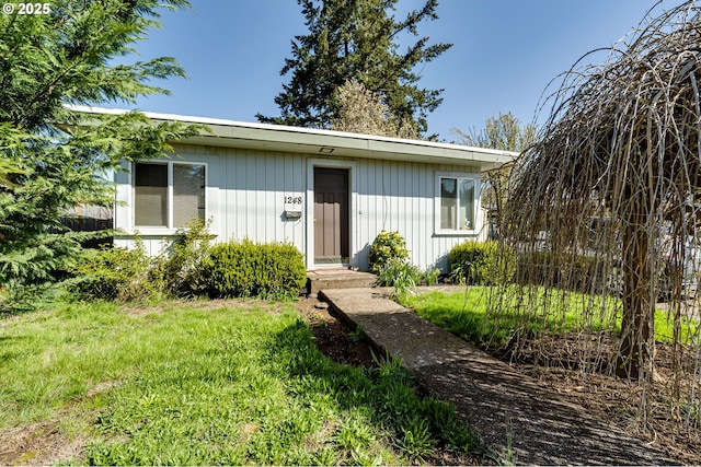 bungalow-style home featuring a front yard