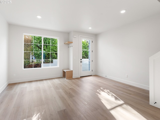 interior space featuring recessed lighting, light wood-style floors, and baseboards