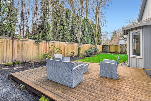 wooden terrace featuring a fenced backyard