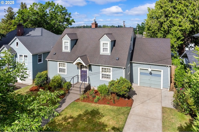 new england style home with a garage and a front lawn