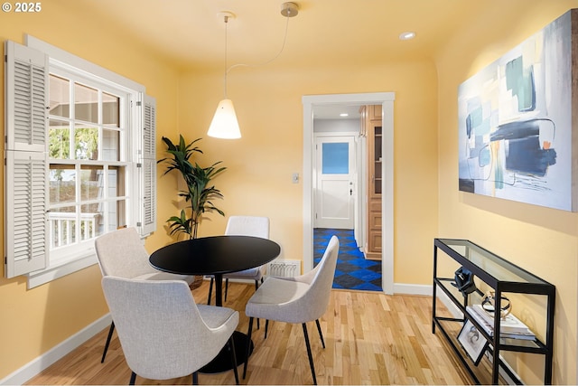 dining area with light hardwood / wood-style floors