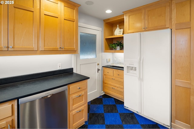 kitchen with stainless steel dishwasher and white refrigerator with ice dispenser