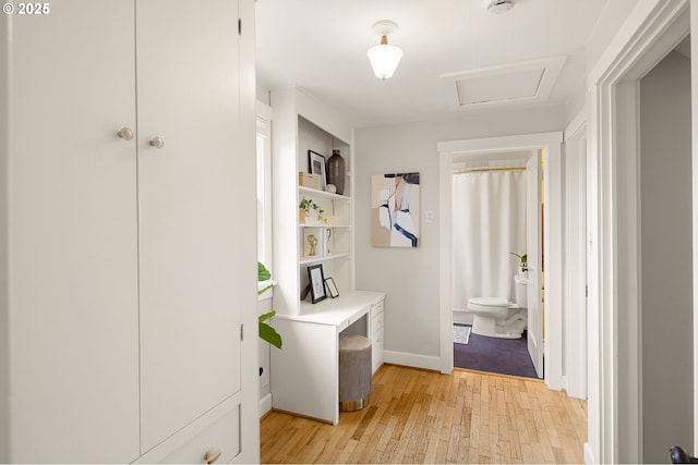 hallway with light hardwood / wood-style flooring