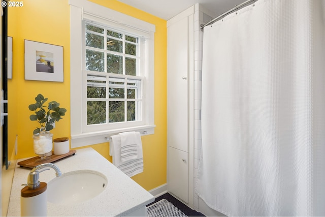 bathroom with a shower with curtain and sink