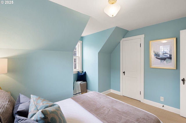 bedroom featuring lofted ceiling and light colored carpet