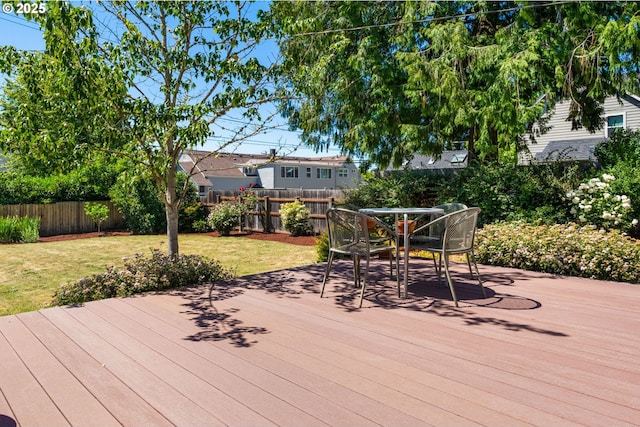 wooden terrace featuring a yard