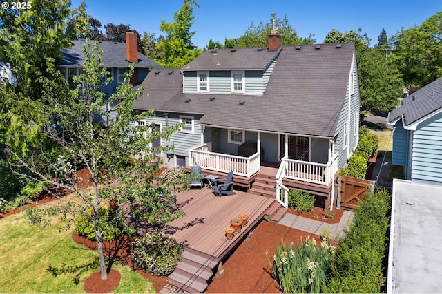 rear view of property featuring a deck