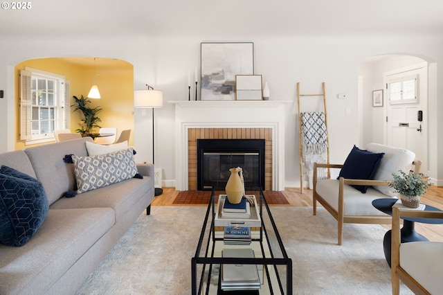 living room with hardwood / wood-style flooring and a fireplace