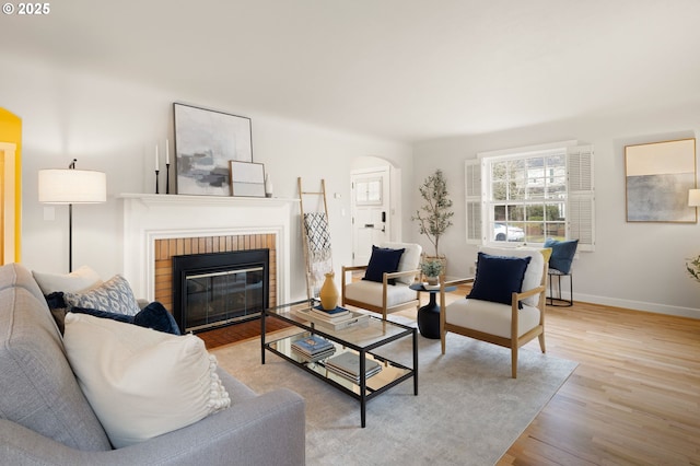 living room with a fireplace and light hardwood / wood-style floors