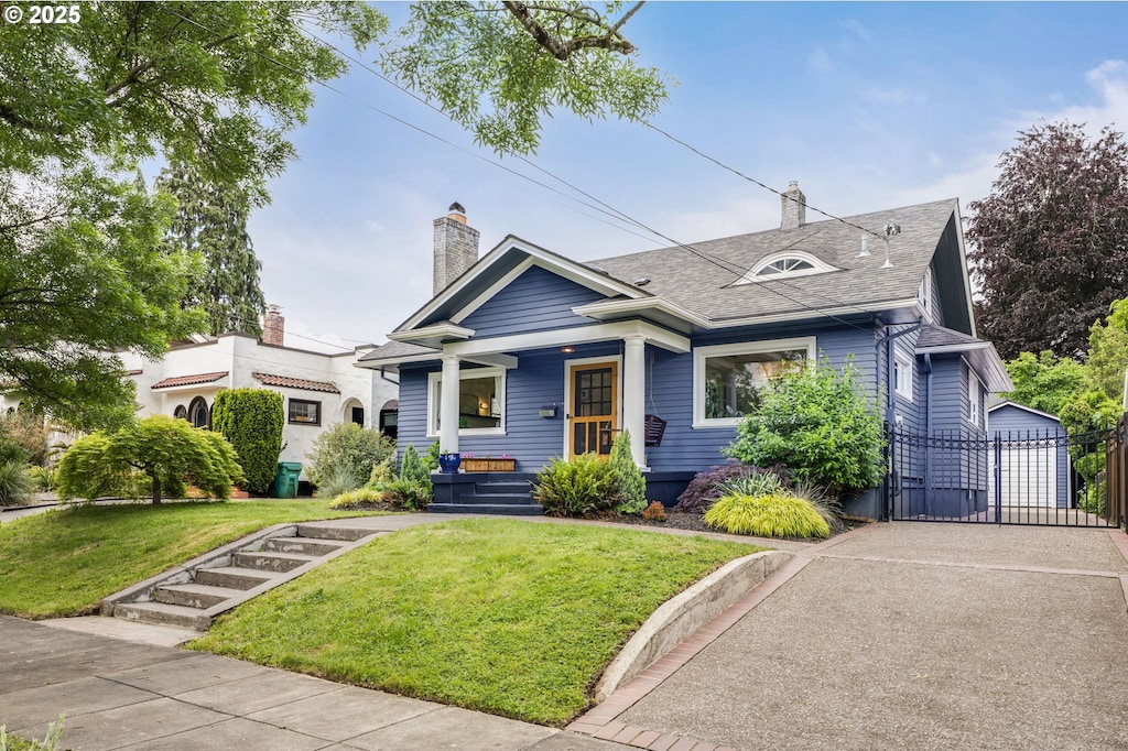 4053 NE 31st Ave, Portland, OR 97212 - view of front of home with a chimney, covered porch, a gate, and a front lawn
